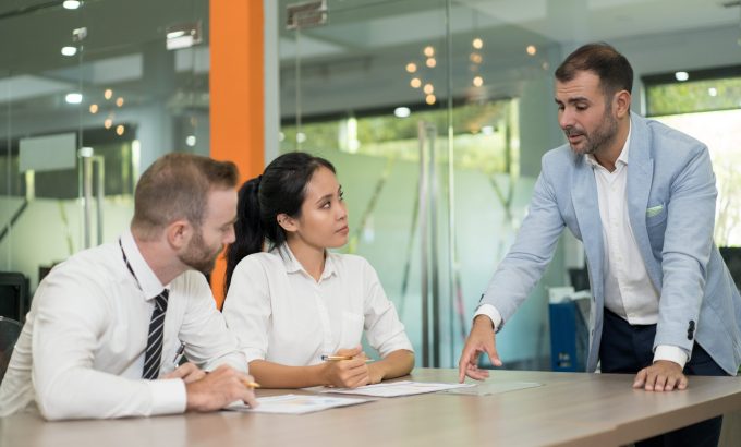 Business man standing and discussing issues with colleagues Business Setup In dubai
